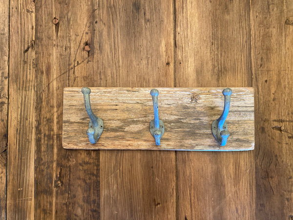 Three Cast Iron Wall Hooks on Reclaimed Barn Wood