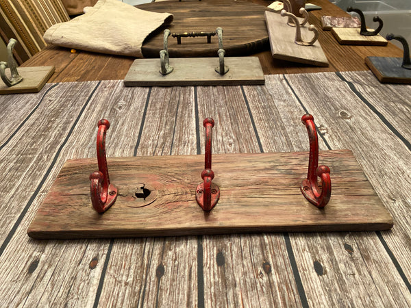 Three Cast Iron Wall Hooks on Reclaimed Barn Wood
