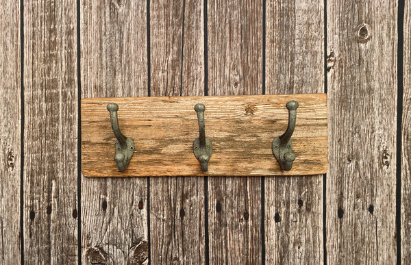 Three Cast Iron Wall Hooks on Reclaimed Barn Wood